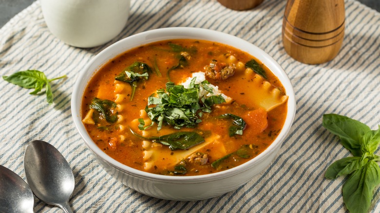 Bowl of lasagna soup with basil on top 