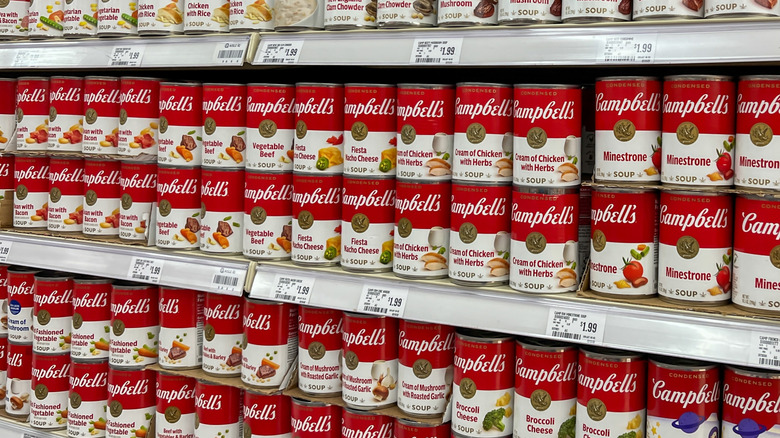 Shelves full of Campbell's soups in a supermarket.