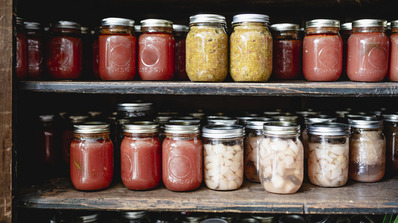 mason jars storing sauce and food on pantry shelf