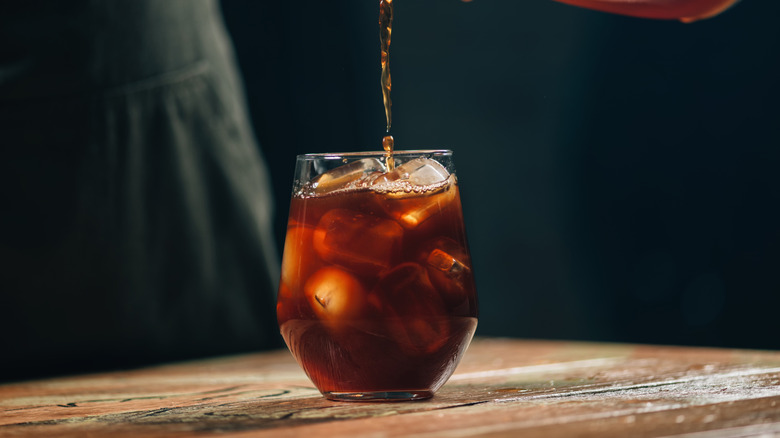 A cold brew coffee being poured.