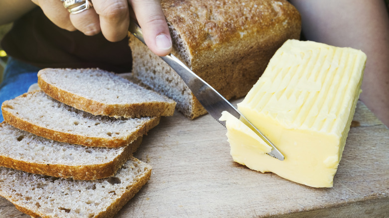 butter on a cutting board with bread