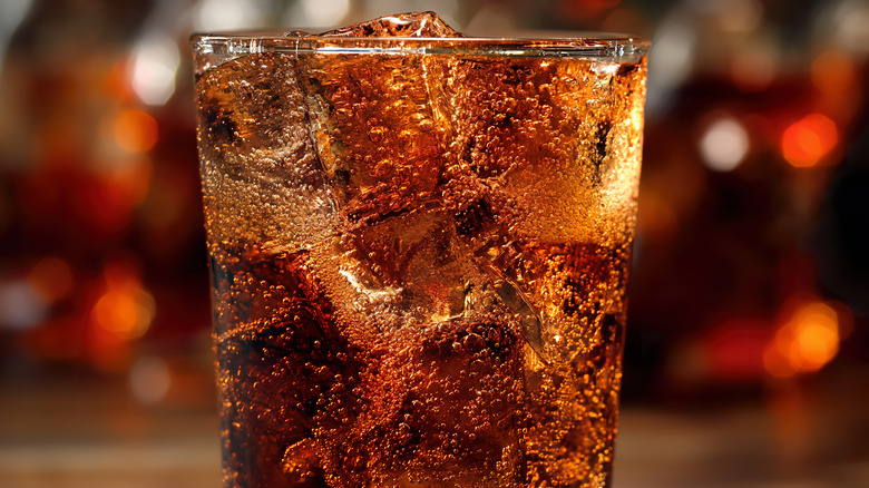 A glass of bubbling soda with ice