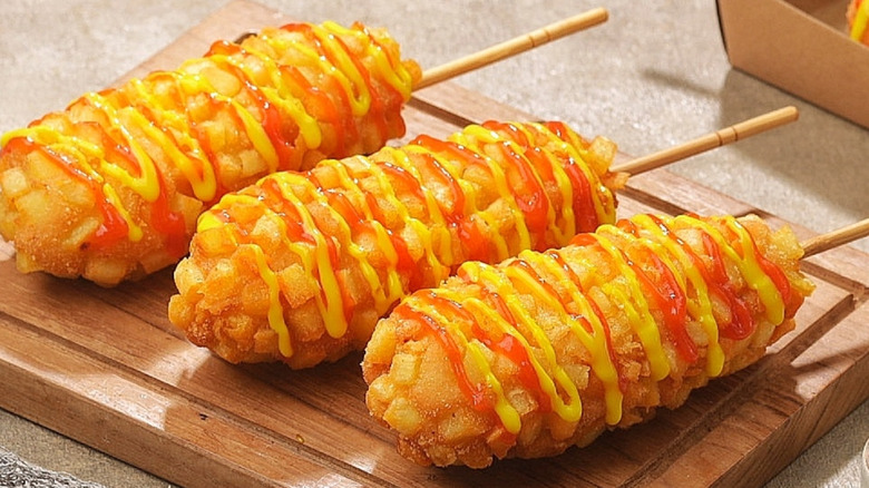 three korean corndogs on platter