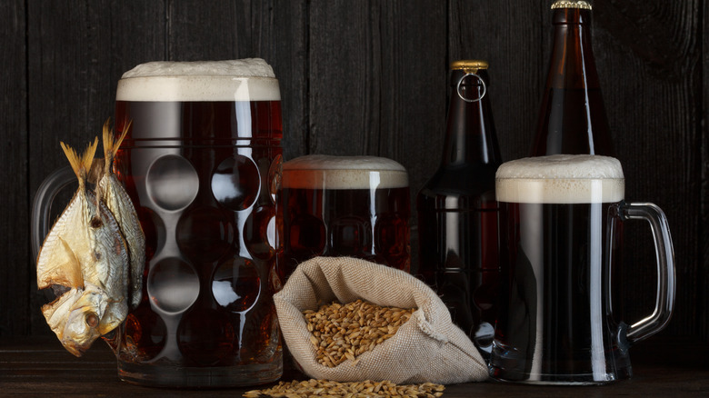 Beer, fish, and grain on a a table