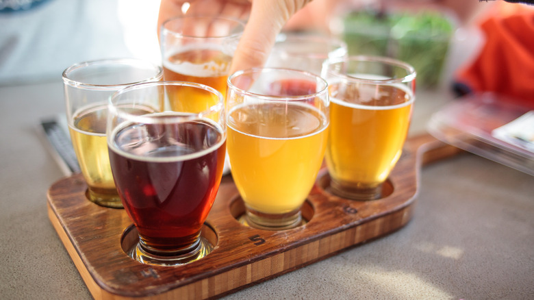 A flight of beers on a table.