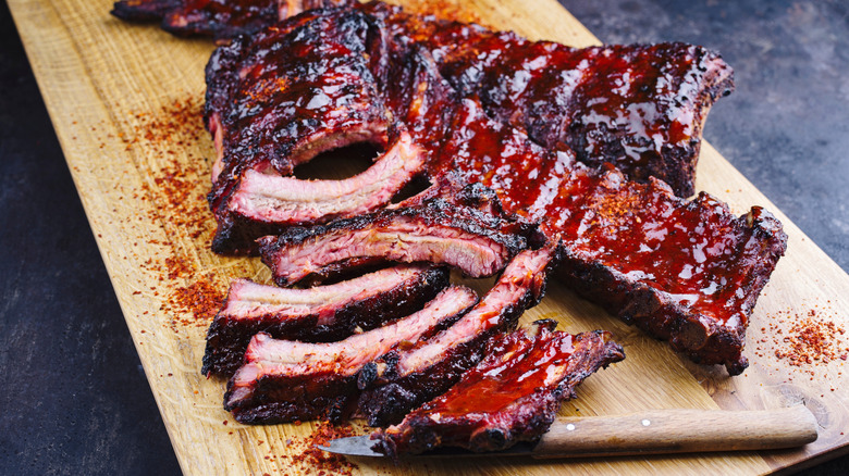 Ribs with barbecue sauce on a cutting board