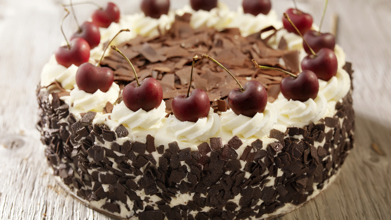 A Black Forest Cake, which typically includes Kirschwasser, on a wooden surface