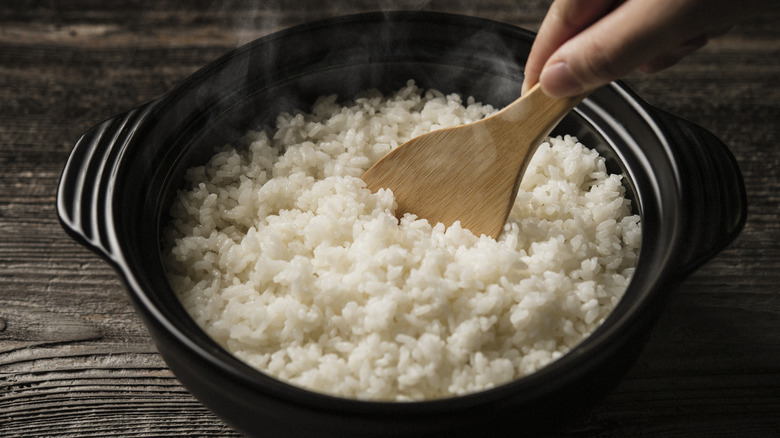 A close up shot of boiled rice in an iron pot