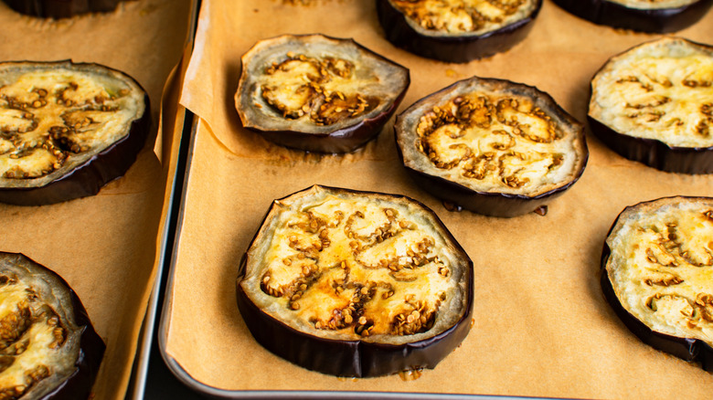 Eggplant slices on a baking pan lined with parchment paper