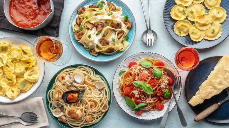 A variety of noodles and pasta dishes on a table