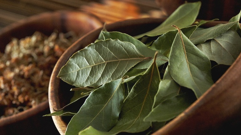 Whole bay leaves in a wooden container