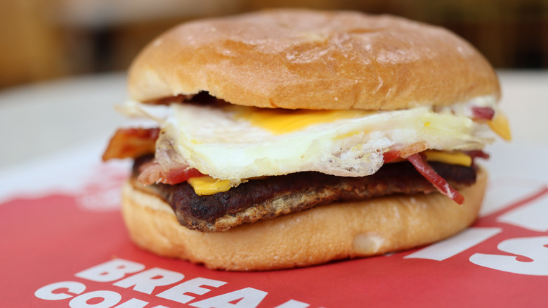 A close up of Wendy's Baconator is shown on a table