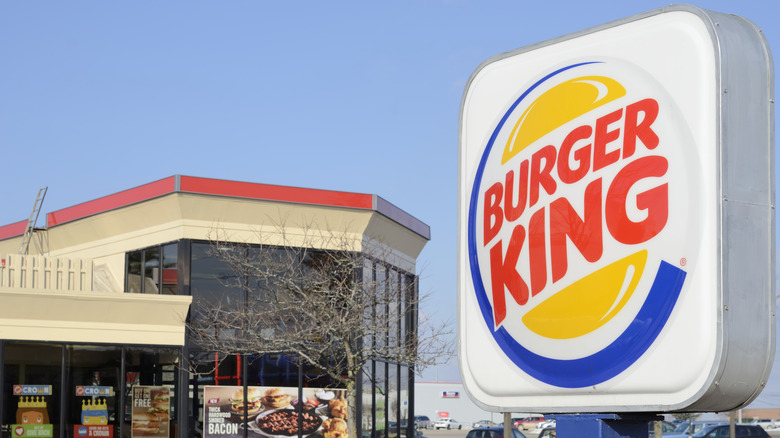 A Burger King sign in front of a Burger King restaurant