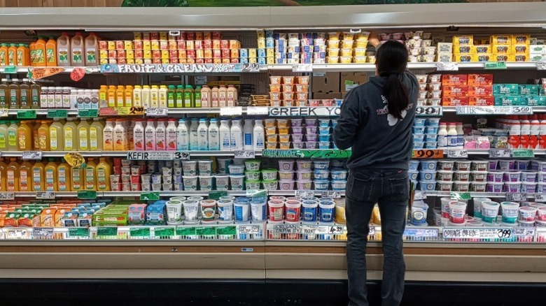 A worker restocks dairy products at Trader Joe's.