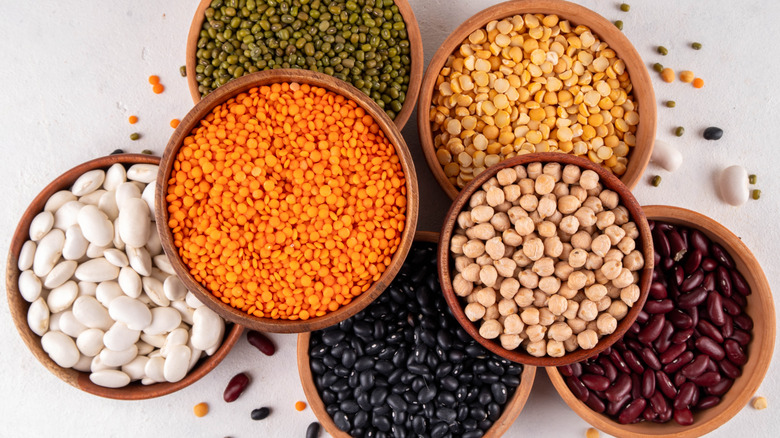 various dried beans in bowls including lentils and chickpeas