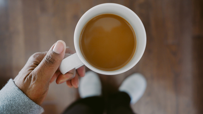 A person holding a cup of coffee