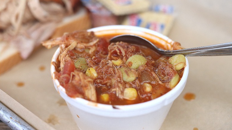 styrofoam cup of brunswick stew with spoon in it