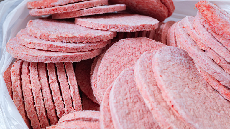 A pile of frozen hamburger patties