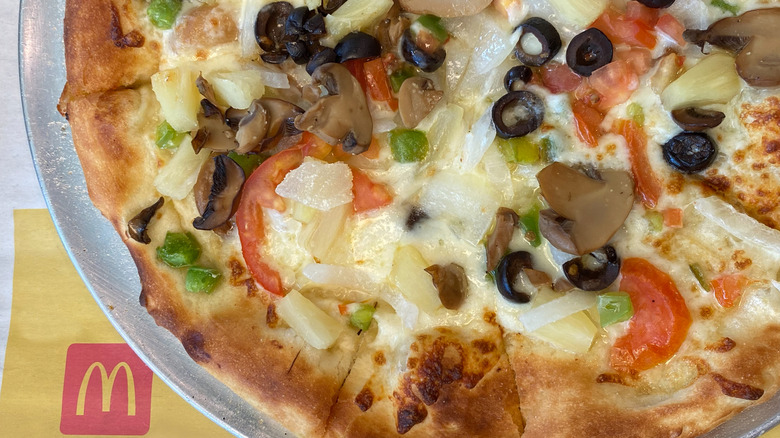 McDonald's Pizza with tomato, mushrooms, green bell pepper, and olives.