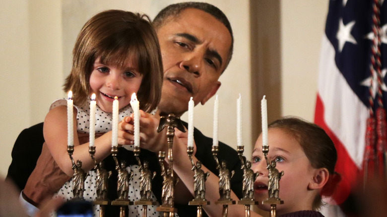 President Obama helps children light menorah at White House