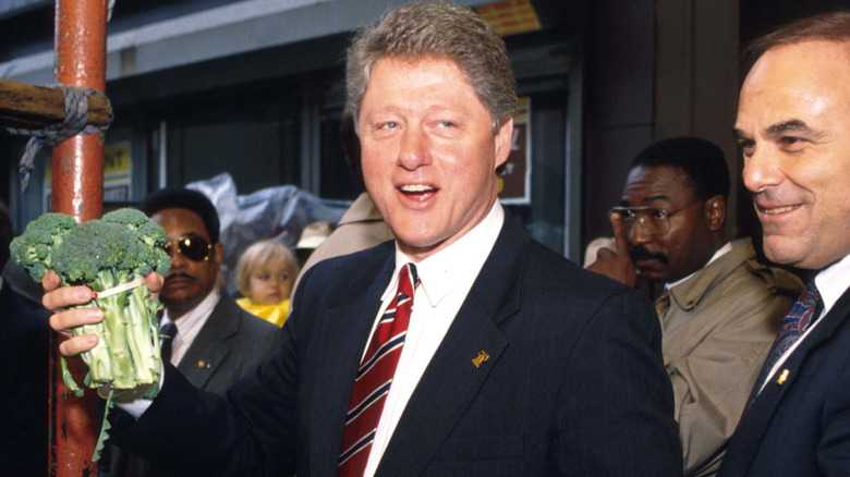 Bill Clinton holds bushel of broccoli