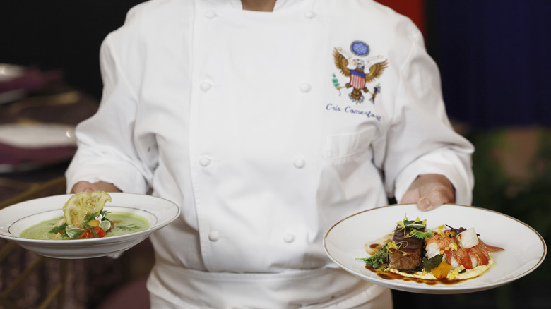 White House chef holding two plates