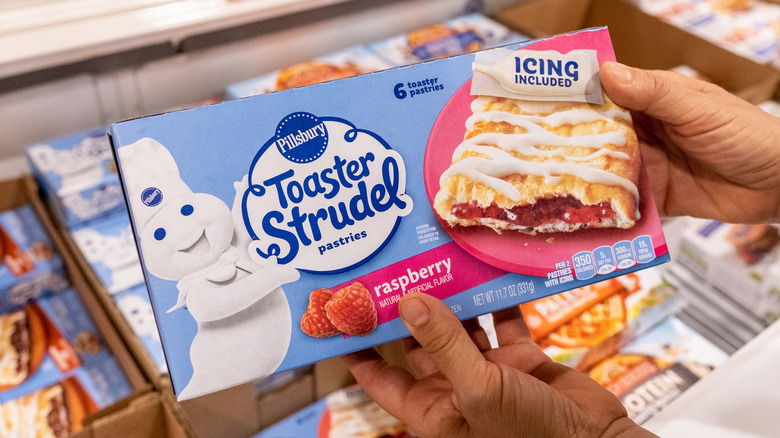 Hands holding a box of Toaster Strudel