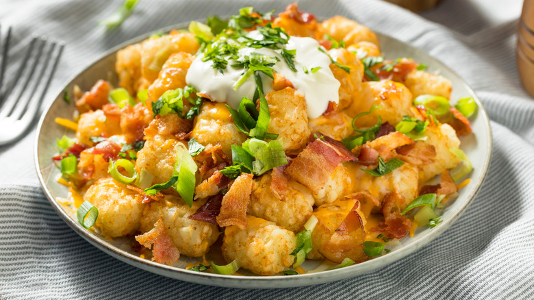 Cheese covered tater tots sprinkled with chives