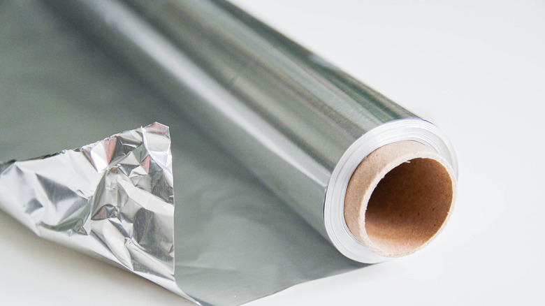 A roll of aluminum foil against a white background