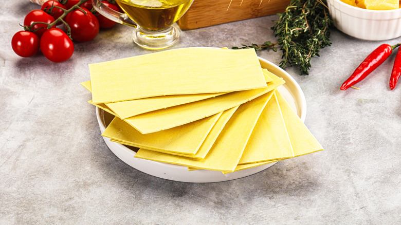 Dry lasagna sheets sitting inside of a bowl