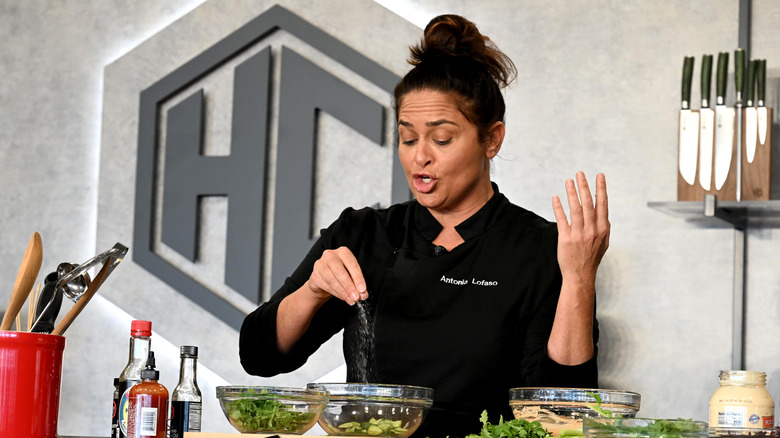 Antonia Lofaso seasoning a bowl of cucumbers