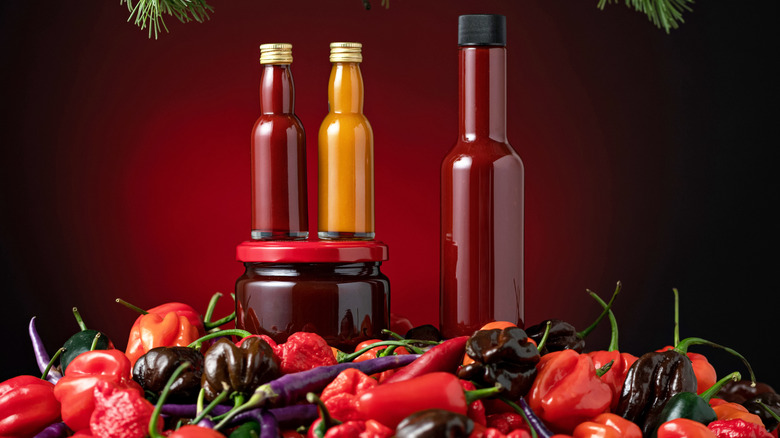 Selection of blank hot sauce bottles and chiles