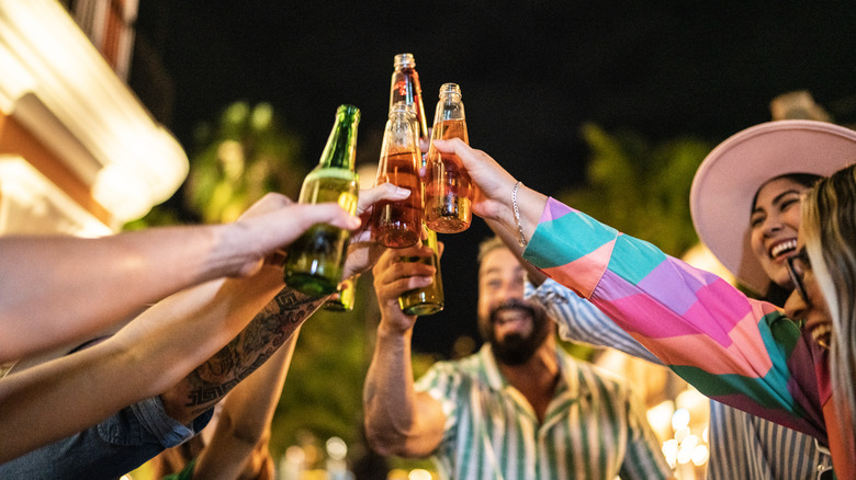 A group of friends cheering with beer