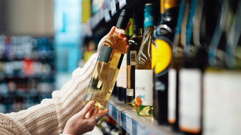 Woman buying alcohol at a store