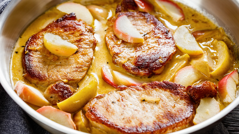 pork chops in a creamy sauce with sliced apples