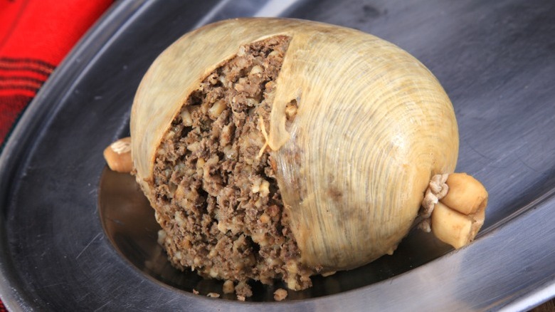 Haggis, a type of savory pudding, on a silver platter.