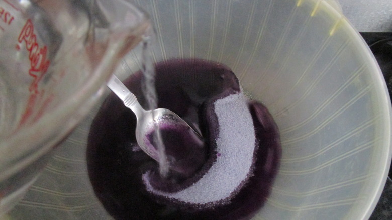 Adding hot water to grape Jell-O powder