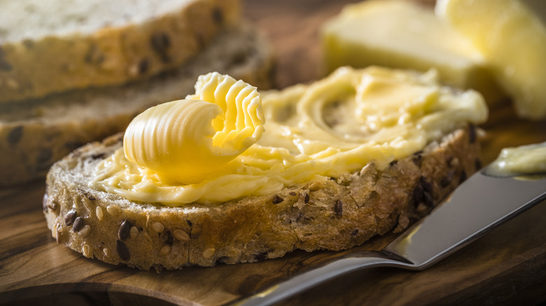 Bread being spread with butter