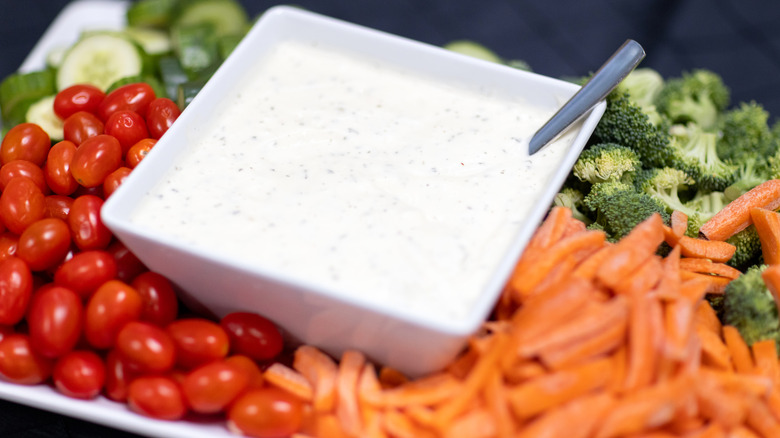 Vegetable platter with ranch dressing in middle