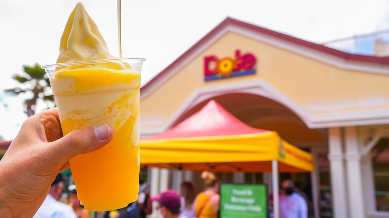 Hand holding Dole Whip float outside Dole pineapple plantation, Hawaii.