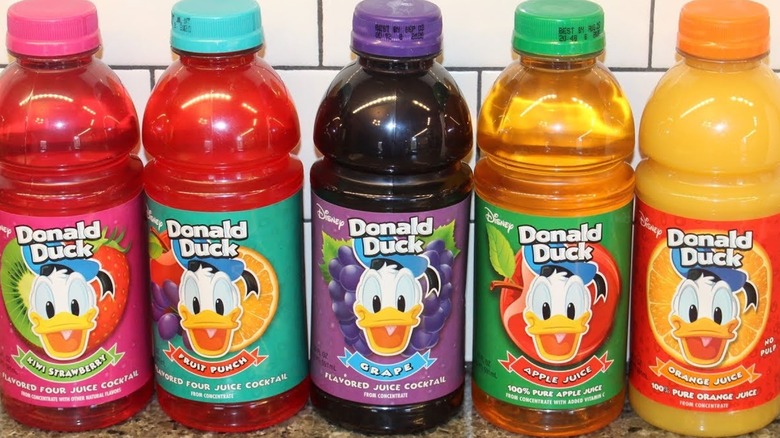 Five different flavors of Donald Duck juice on a countertop