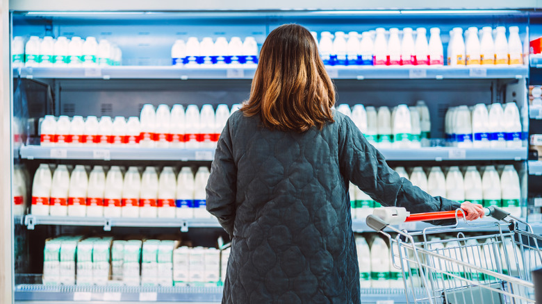 woman starting at milk shelves