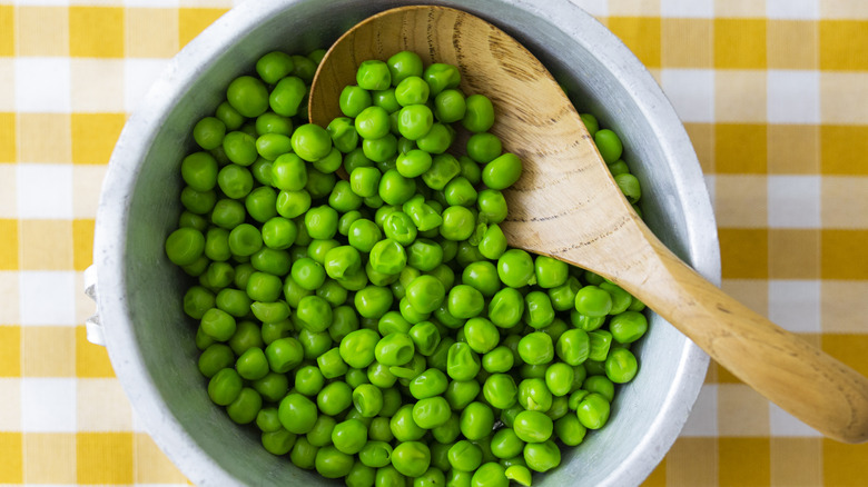 cooked peas in bowl with spoon