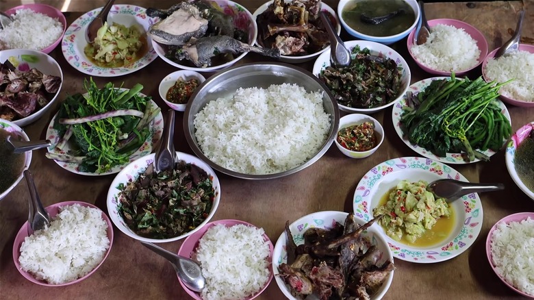 Various Hmong dishes sitting on a table.