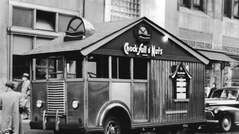 A historic black and white photo of a novelty Chock Full o' Nuts truck in New York City.