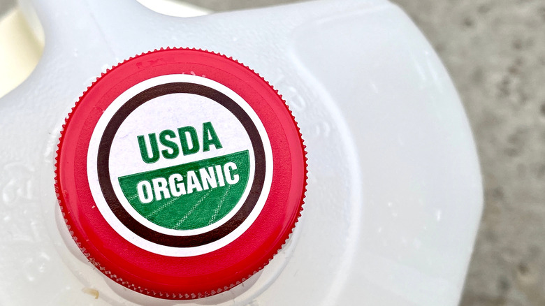 USDA organic sticker on a gallon of milk.