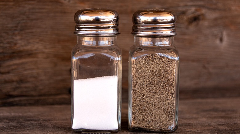 Salt and pepper shakers on a wooden table