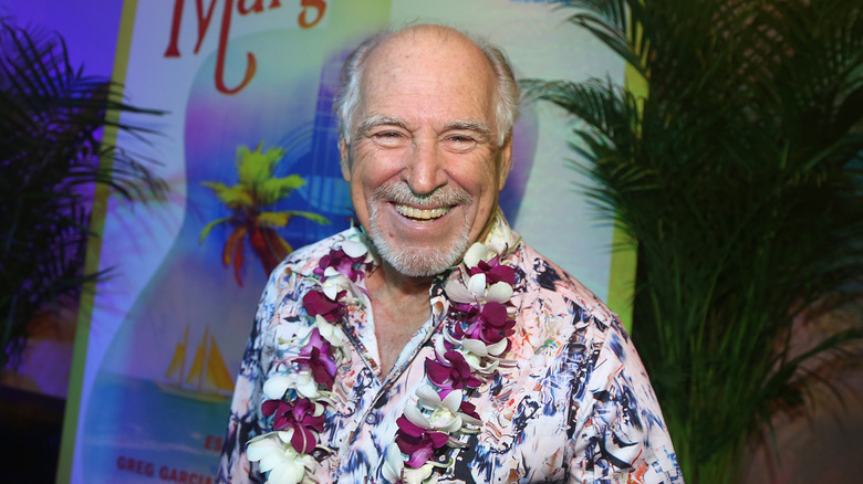 Jimmy Buffett smiling in a Hawaiian shirt at a Margaritaville event