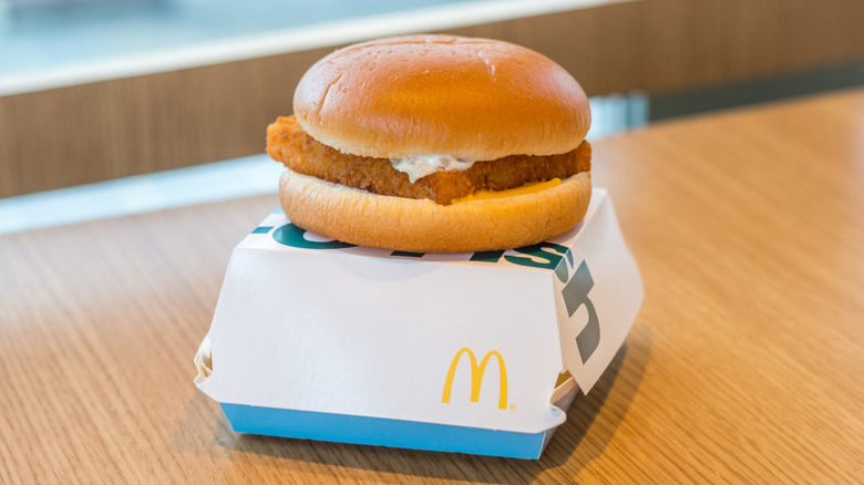 a McDonald's filet-o-fish sandwich resting on top of its box