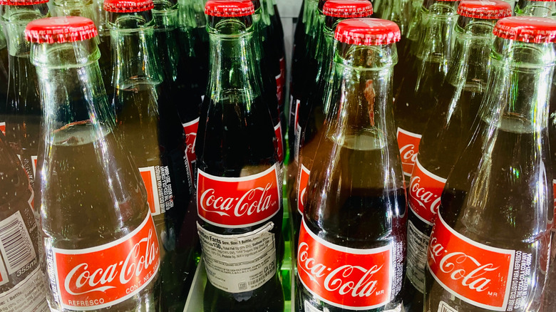 Bottles of Mexican Coke in a fridge.